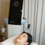 Person lying on a white mat with a Microneedling RF device displaying a graph.